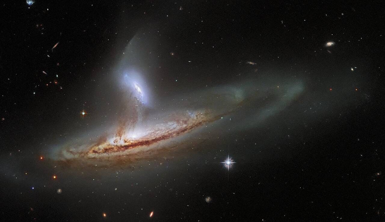 کهکشانی که دارد شیره جان همدمش را میمکد   کهکشانی که دارد شیره جان همدمش را میمکد