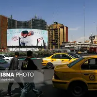 عکس/ رونمایی از دیوار نگاره میدان ولیعصر با عکسی خاص از سردار سلیمانی و شهید رئیسی