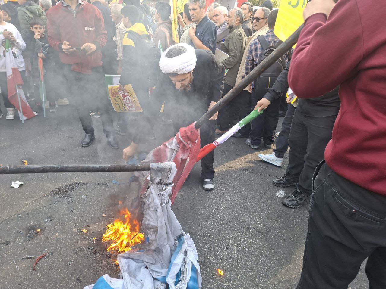  عکس/آتش زدن پرچم آمریکا و اسرائیل در راهپیمایی ۱۳ آبان
